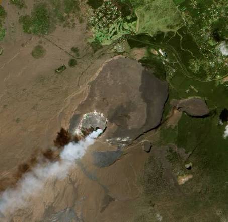 Aerial satellite view of the Halemaʻumaʻu crater within the Kīlauea caldera on the Big Island of Hawaii, with a volcanic gas plume rising from the crater floor.