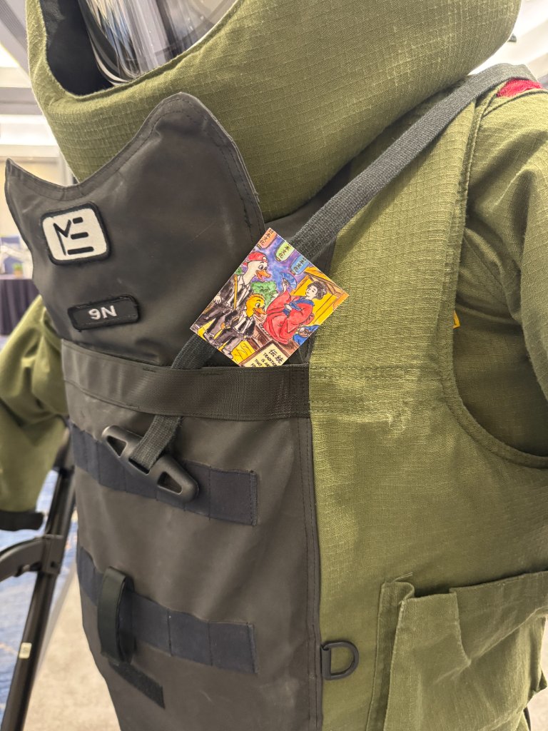 Tradition duck card tucked into the pocket of a tactical vest