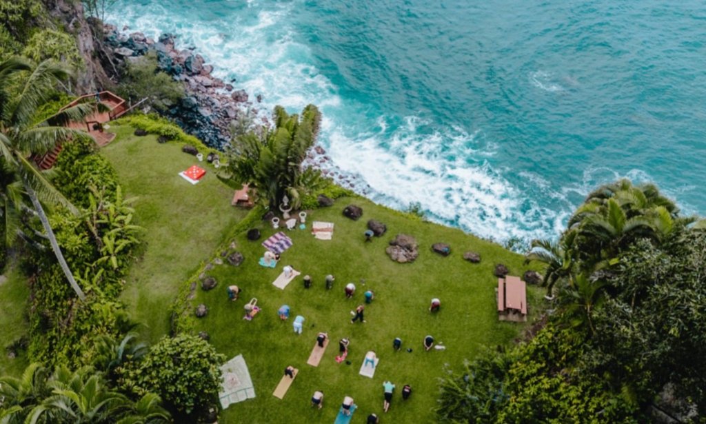 Pilgrims gathered on the cliffside lawn above the ocean
