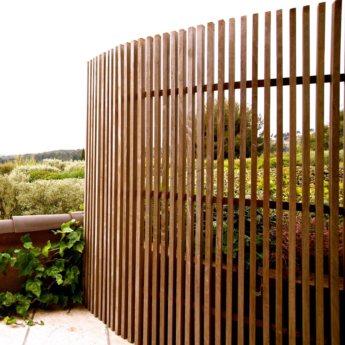 Bespoke slatted timber fence integrated with landscape