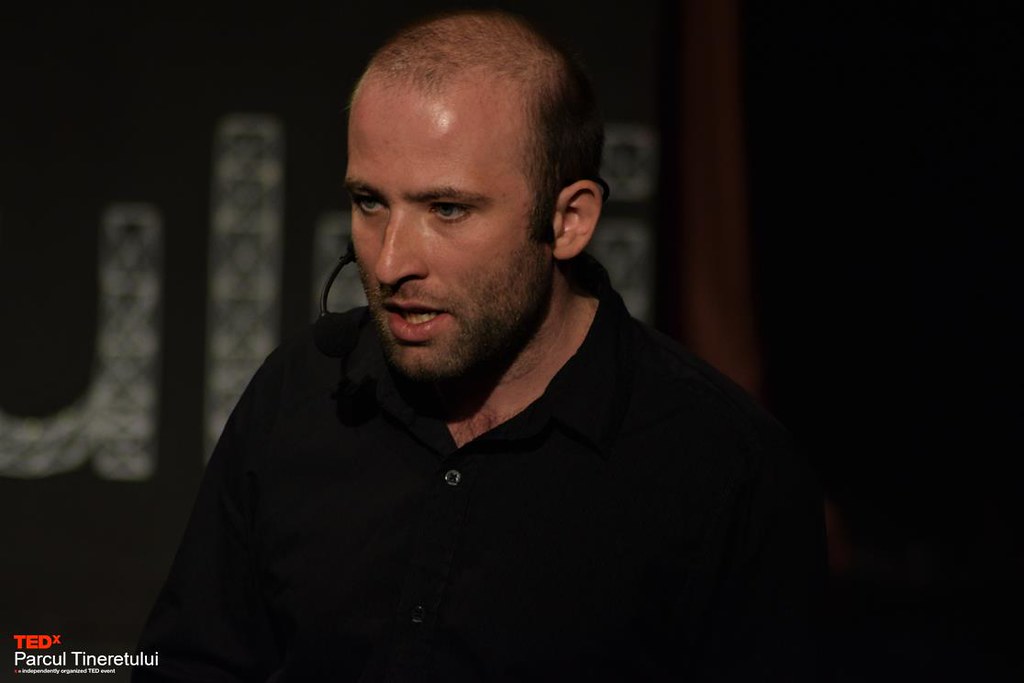 Radu speaking on stage
