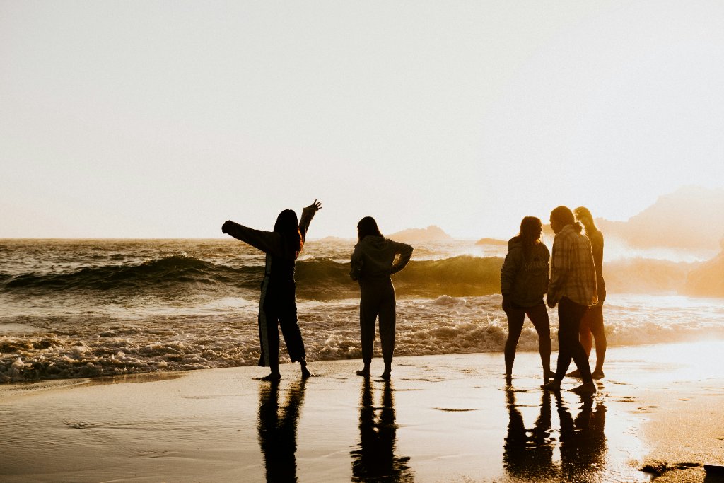 People enjoying the coast at sunset
