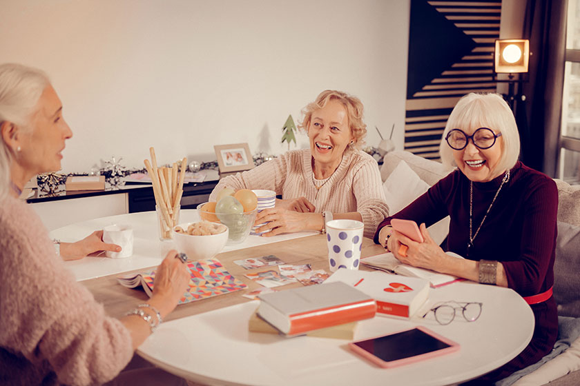 Women laughing at a social table