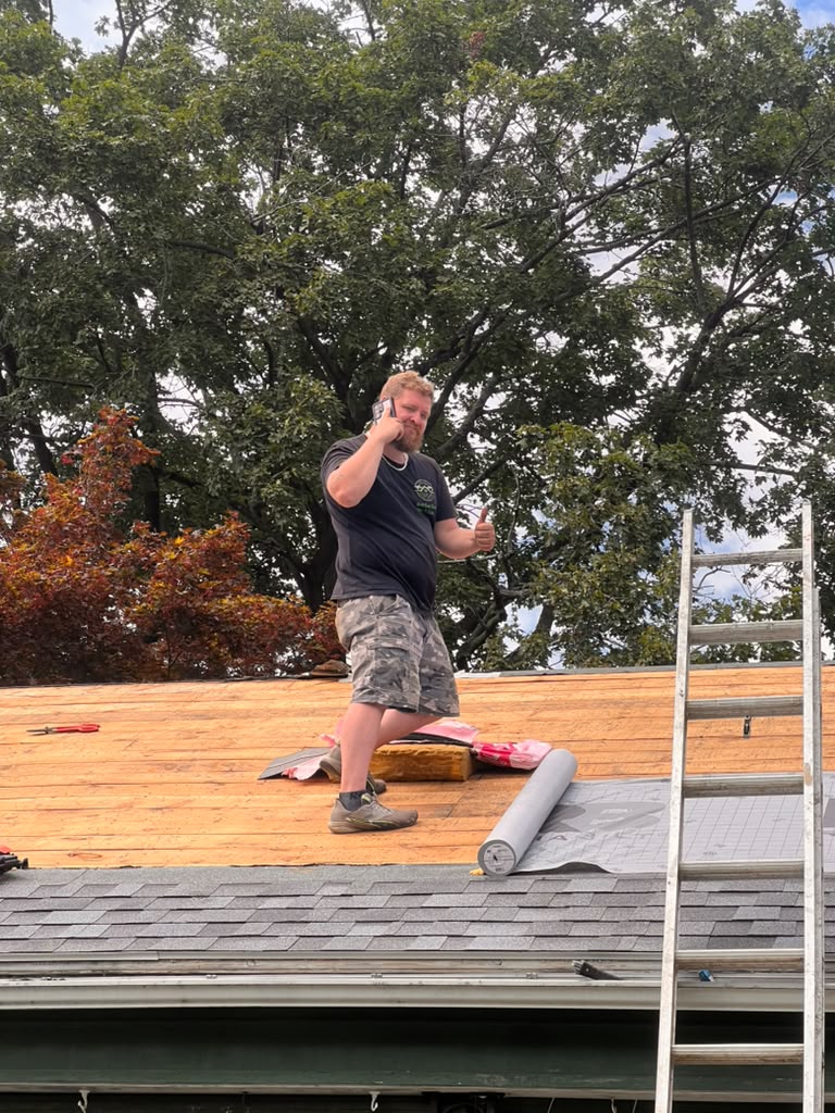 Josh — Owner of First Class Property Services LLC, on the roof mid-job
