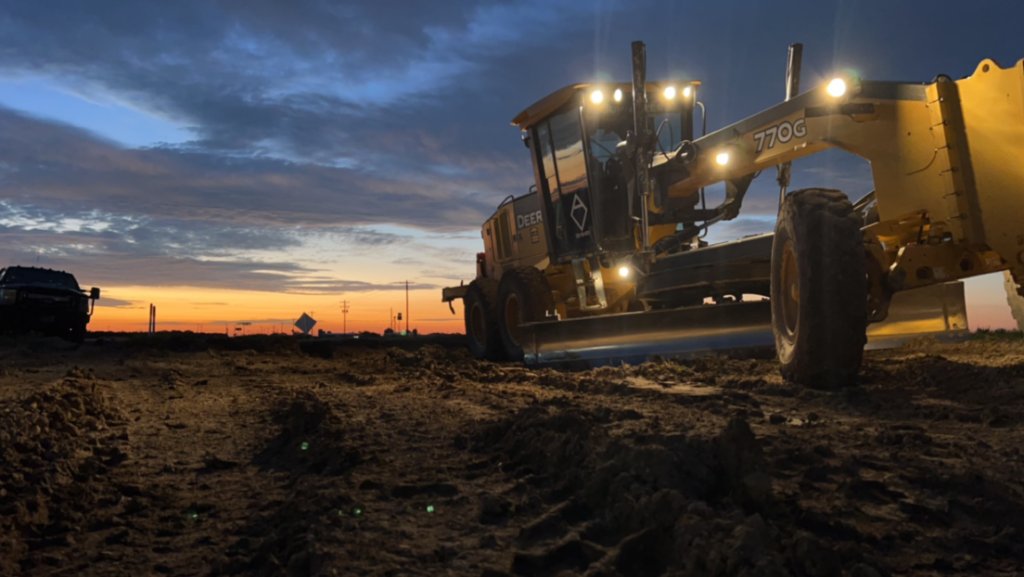John Deere 770G Motor Grader at Dusk