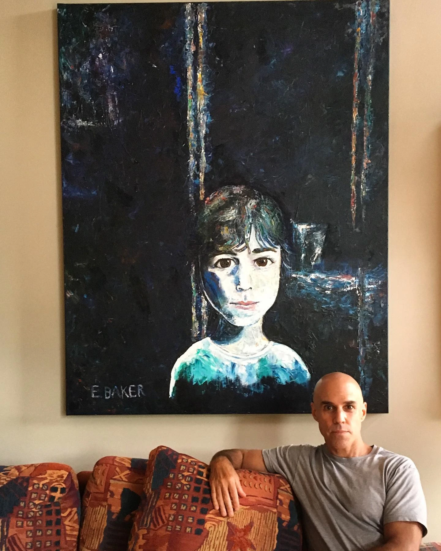 Ed beneath one of his paintings