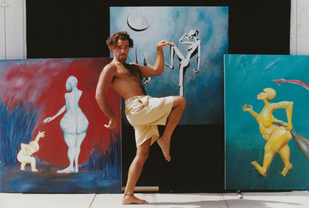 Ed with his paintings