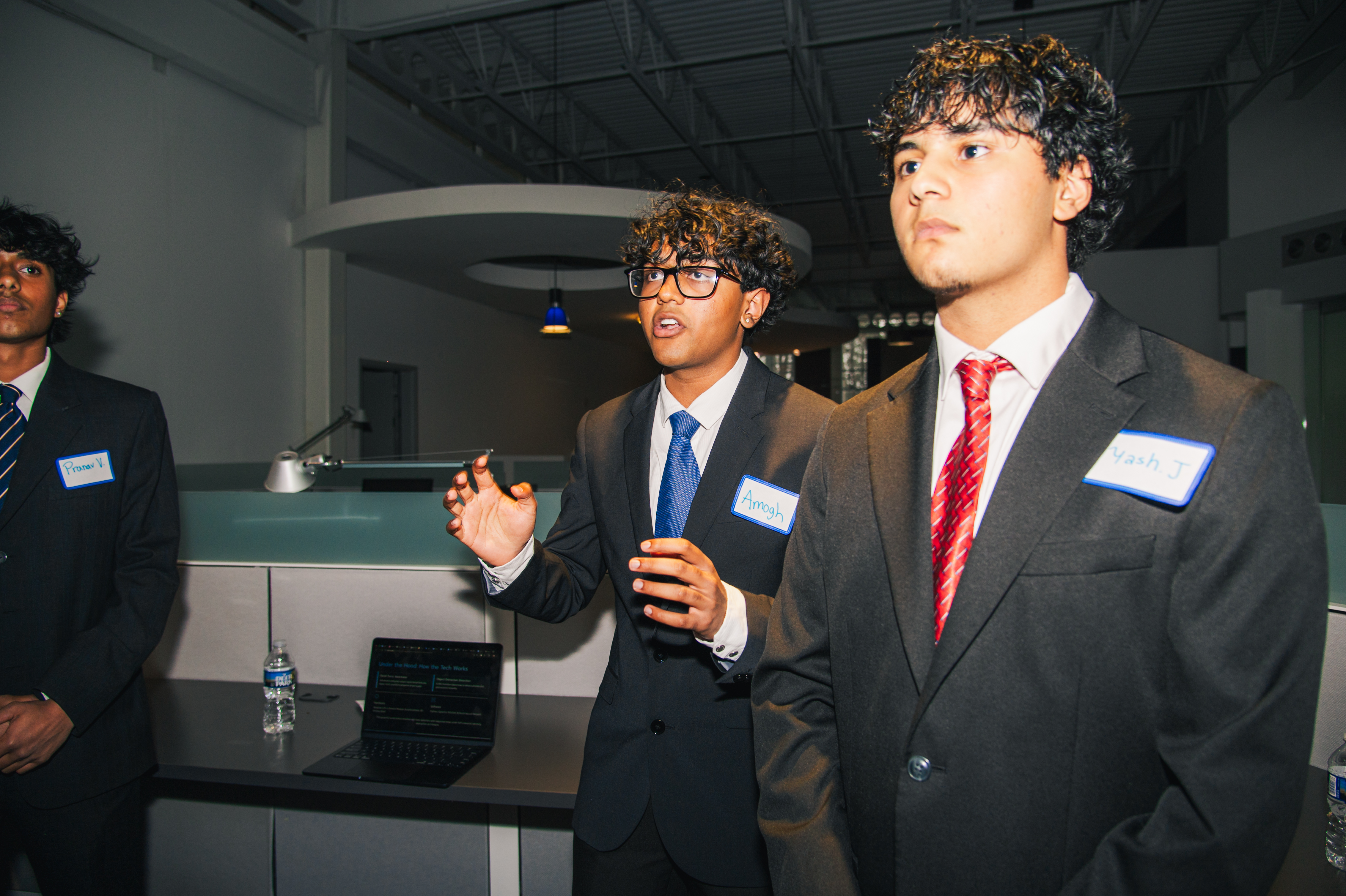 Three participants talking through their pitch at Startup Spotlight