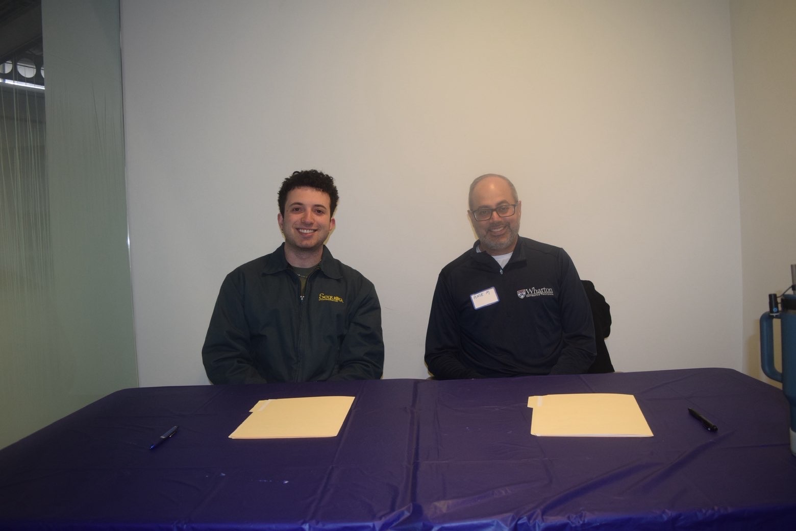 Two judges seated at a table at Startup Spotlight