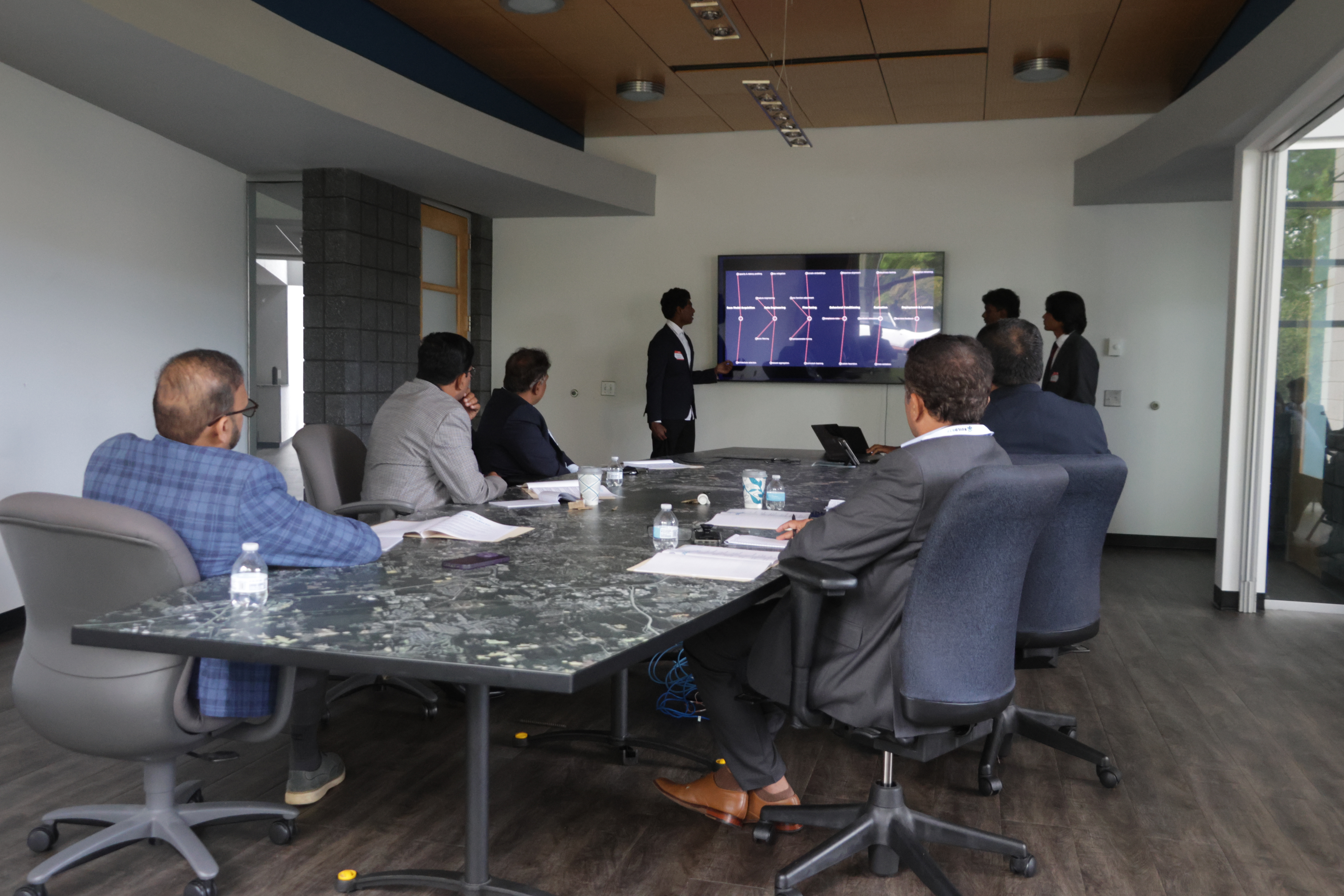 A presenter explaining a workflow diagram during Launch Up