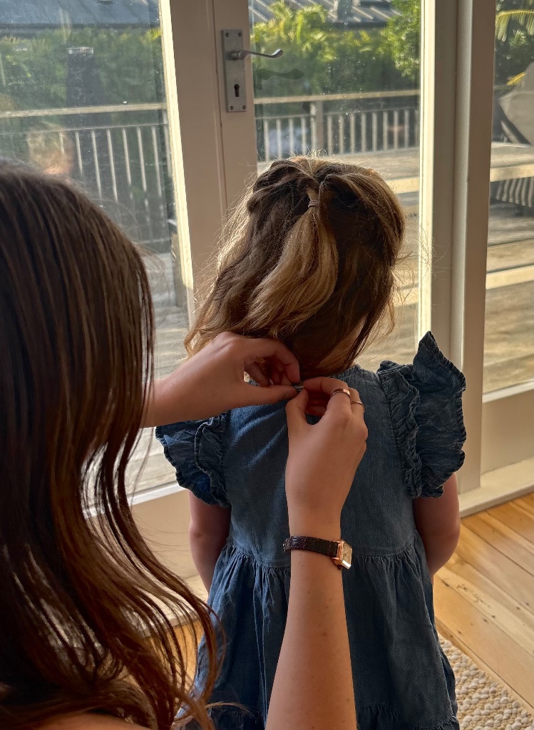 Fastening a girl's dress