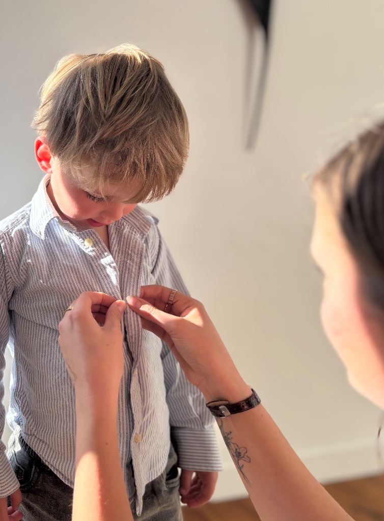 Helping a boy with his shirt