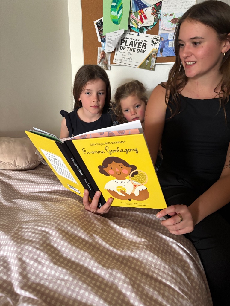 Reading a book to children on the bed