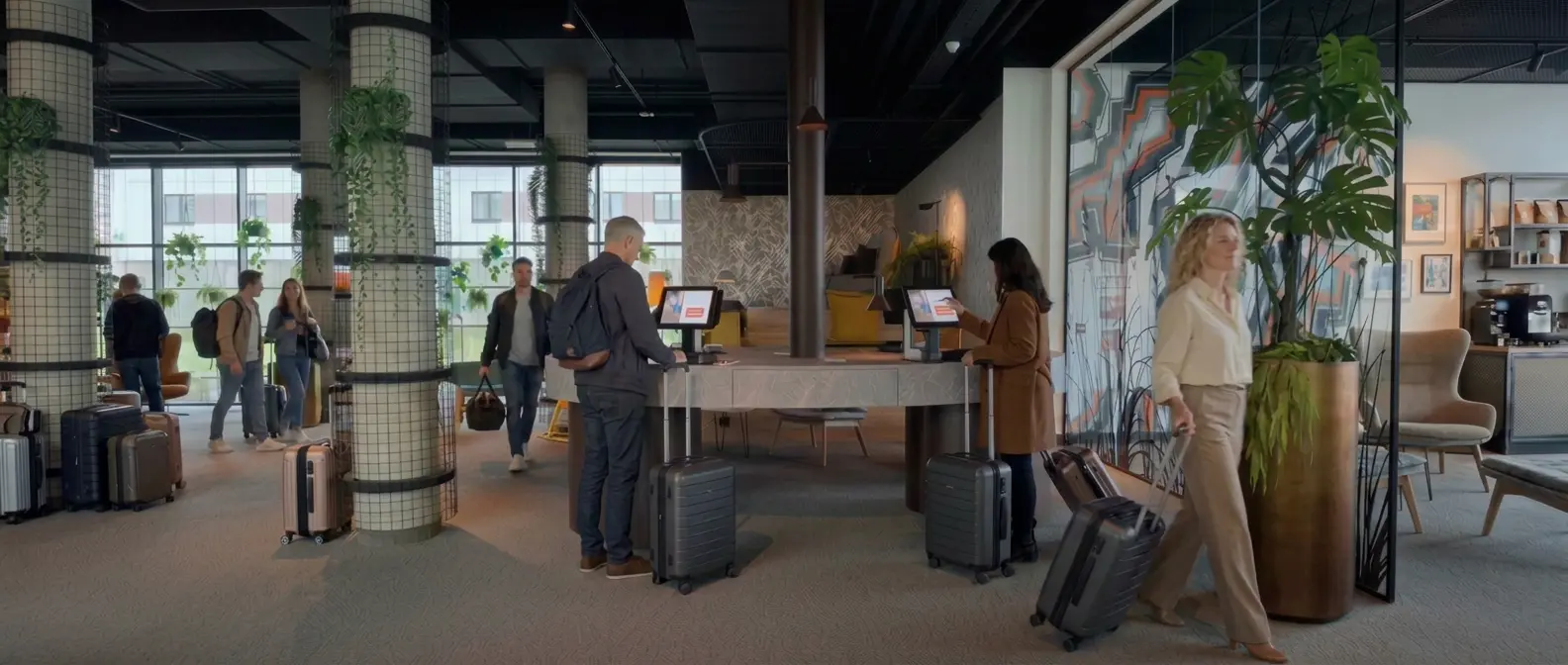 Guests checking themselves in at Enzosystems kiosks in a modern hotel lobby