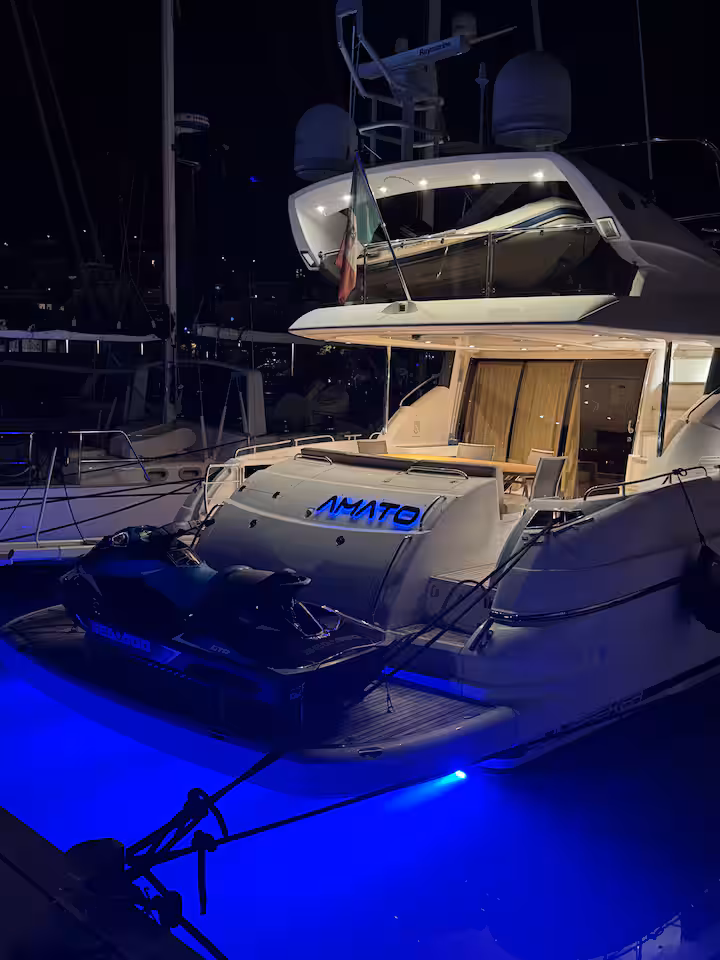 Amato lit up at night — jetski on swim platform