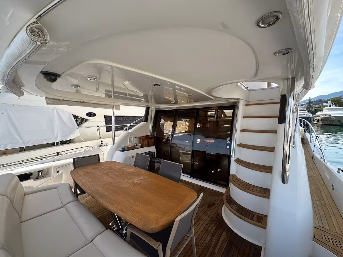 Aft cockpit dining — teak deck and steps to flybridge