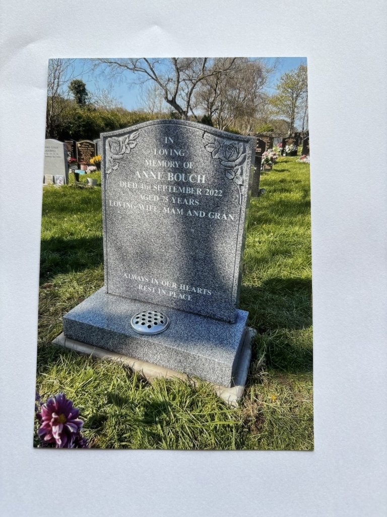 Grey granite headstone with rose carvings