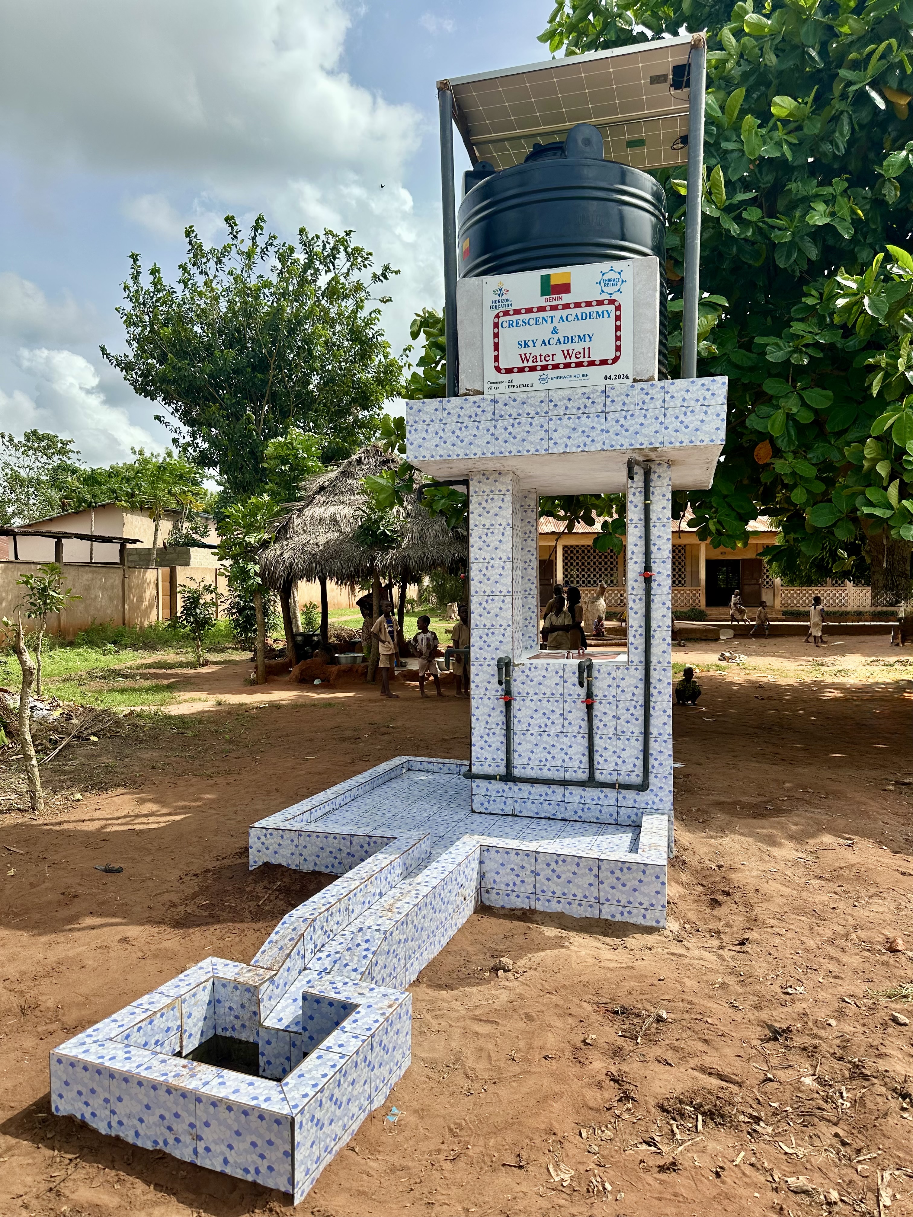 Students drinking clean water from the new well in Benin