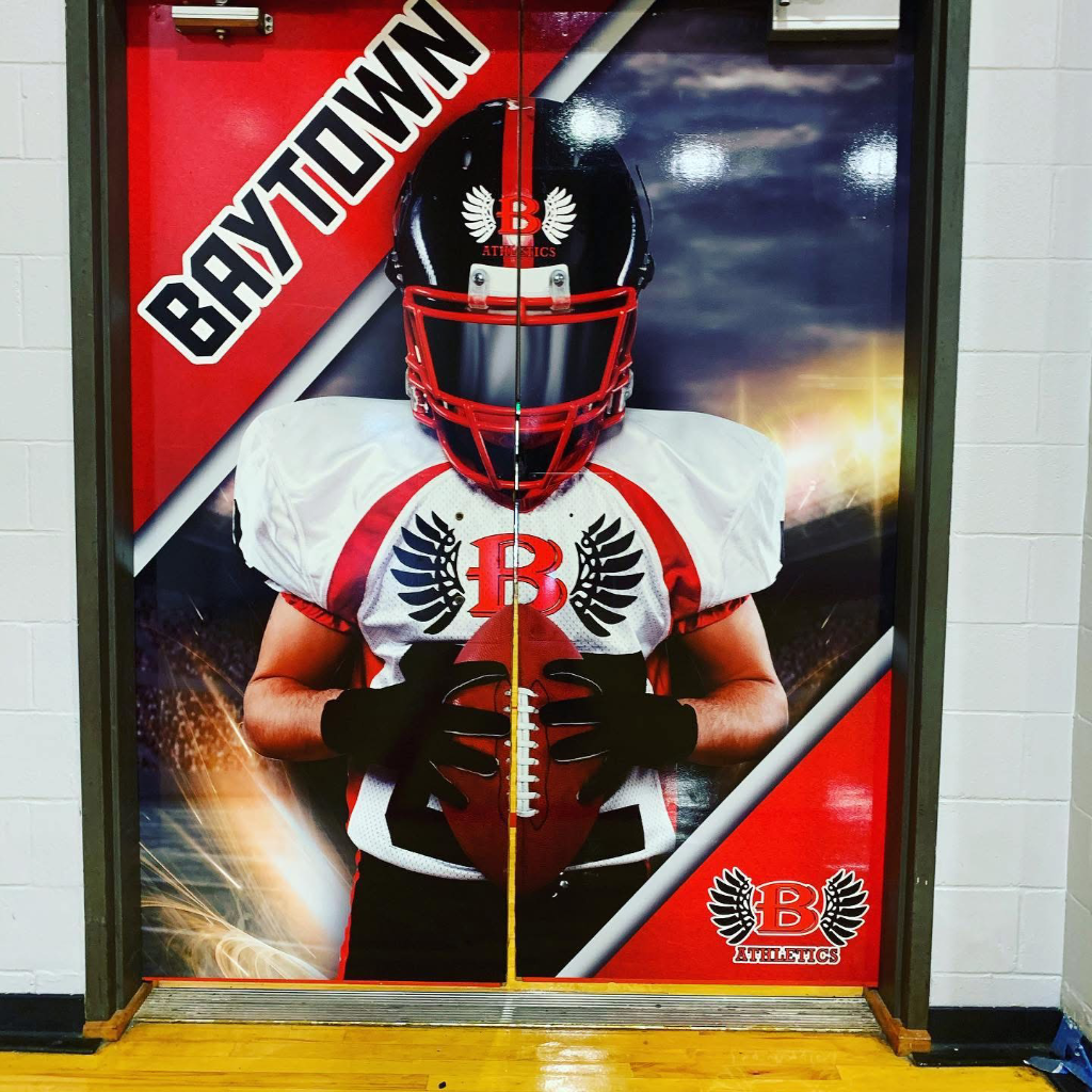Baytown Athletics door wrap with football player graphic