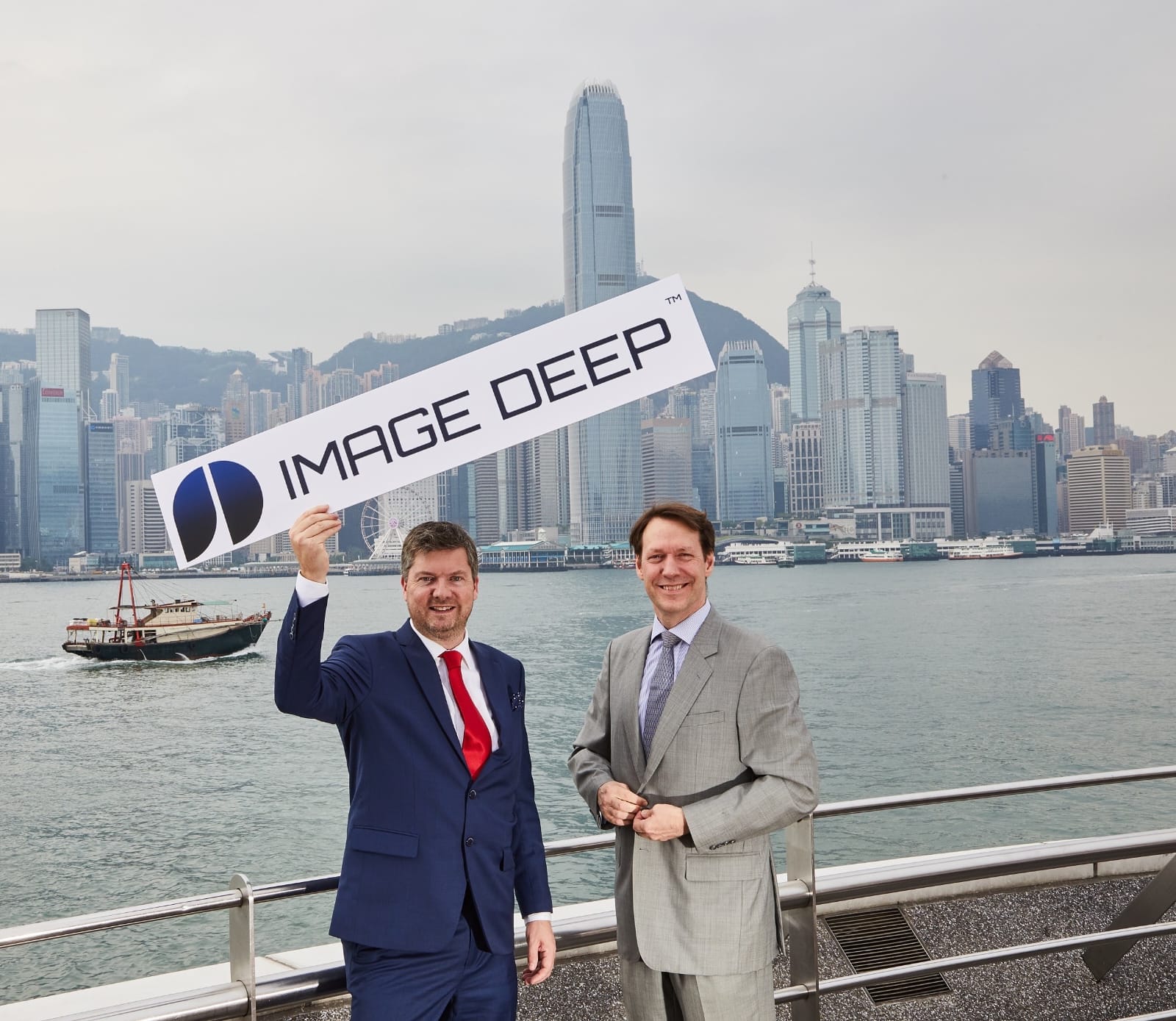 ImageDeep team with the ImageDeep sign in front of the Hong Kong skyline