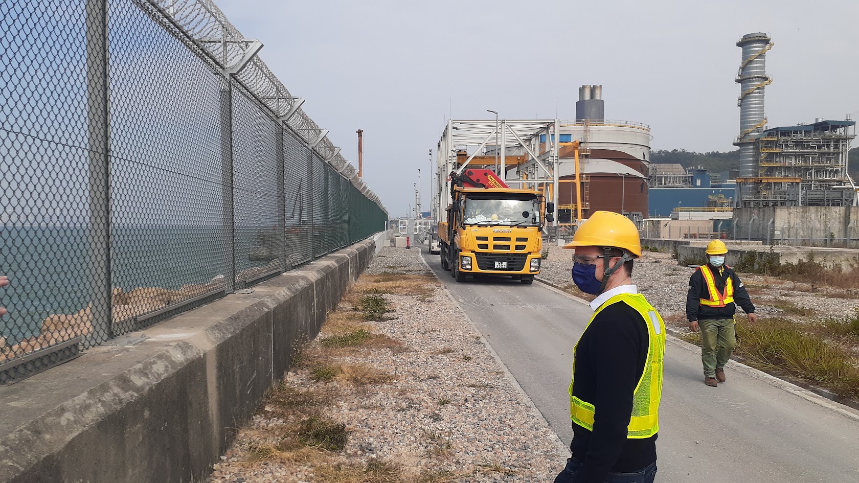 ImageDeep engineers inspecting a razor-wire perimeter fence at a critical infrastructure plant