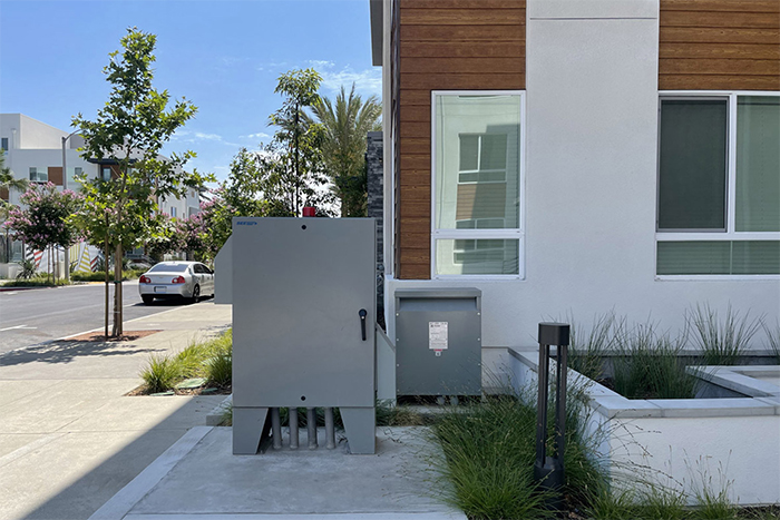 Two utility control cabinets installed on a concrete pad