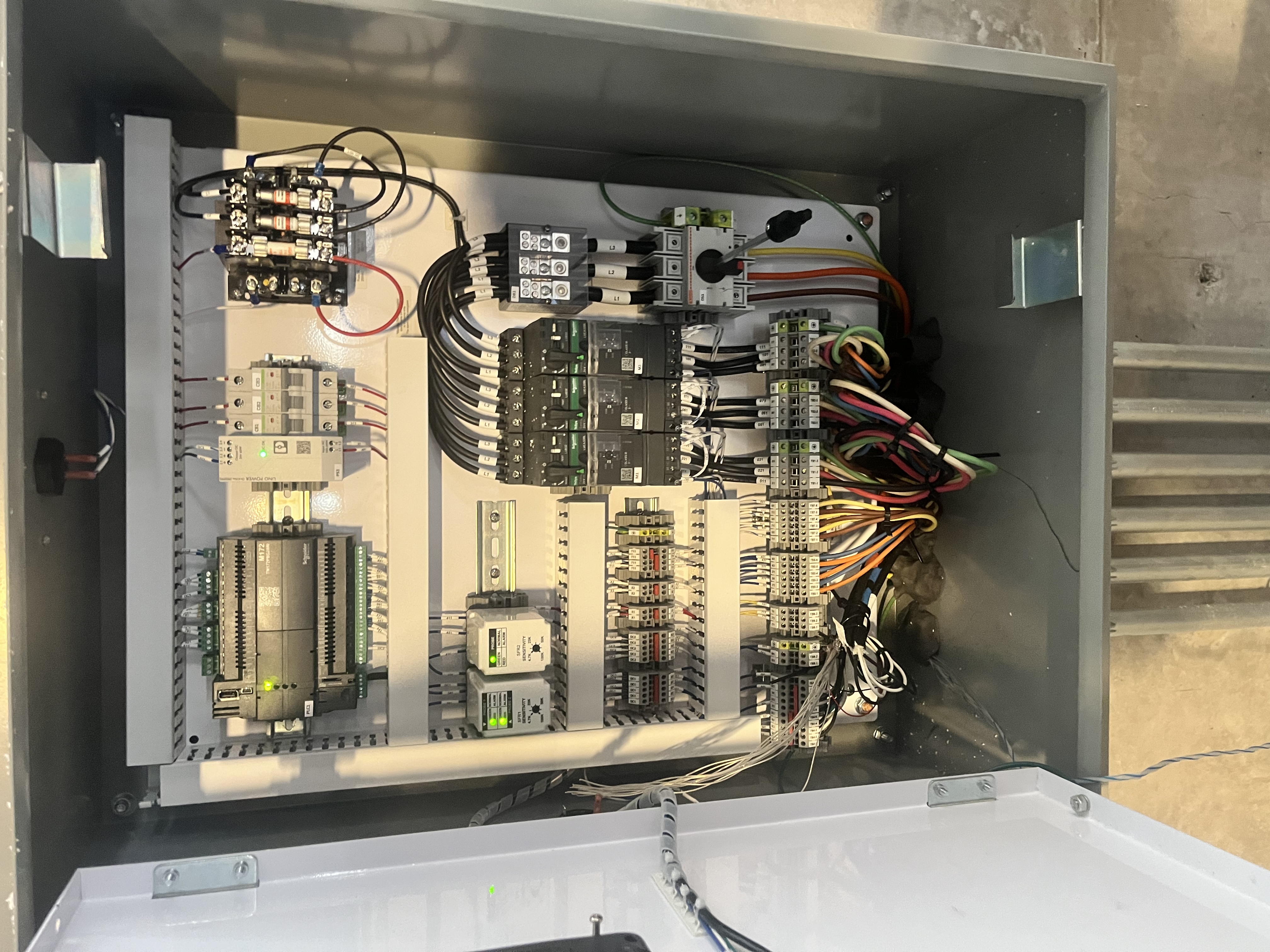 Open pump control panel with contactors, PLC and wiring