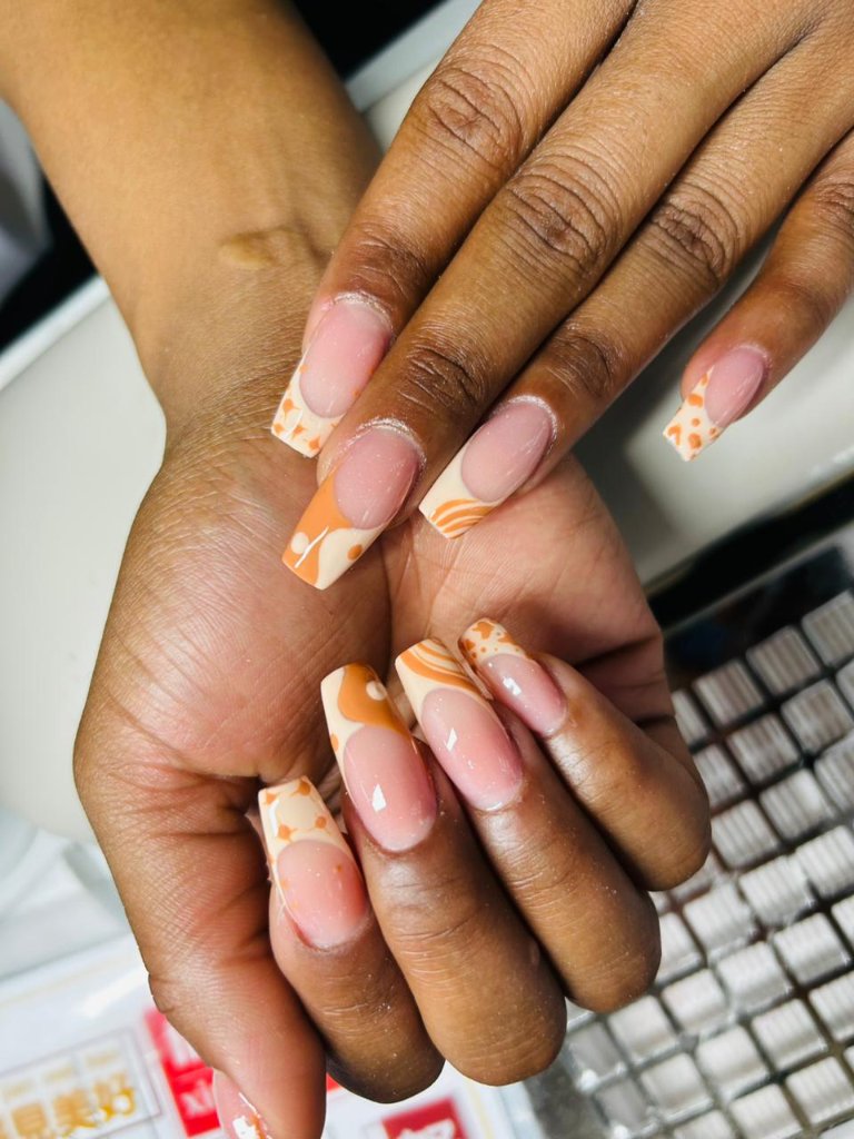 Orange nail art at Crystal Waters Spa Emalahleni