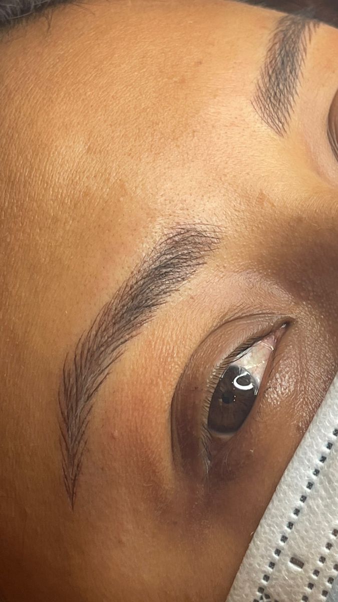 Fine hair-like microblading strokes creating a natural-looking eyebrow
