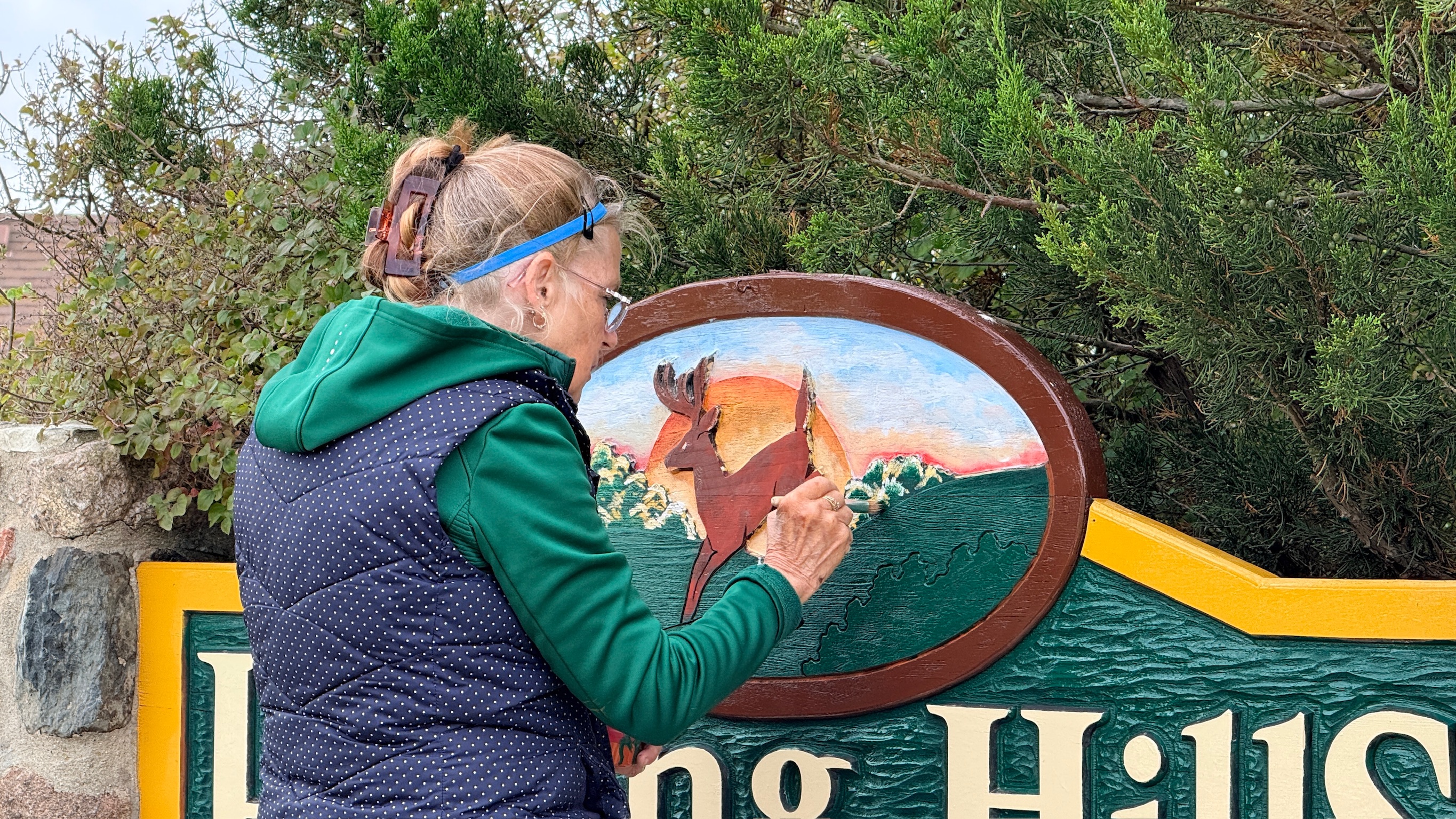 Sandy adding fine details to the deer medallion