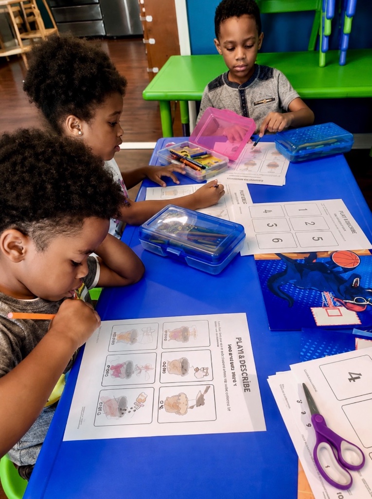Math & Literacy Worksheets Children working on math and literacy worksheets with crayons and scissors at the learning table at Insight Kidz Care Baltimore