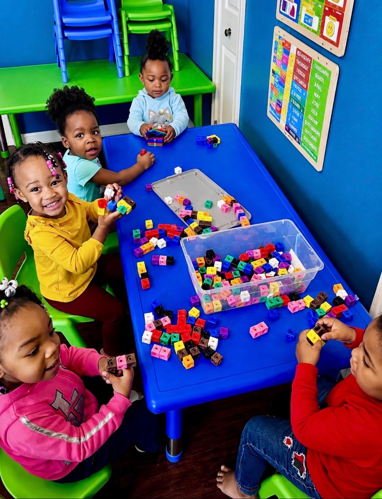 Snap Cubes Math Activity Children connecting colorful snap cubes together in a math and fine motor skills activity at Insight Kidz Care early childhood education program