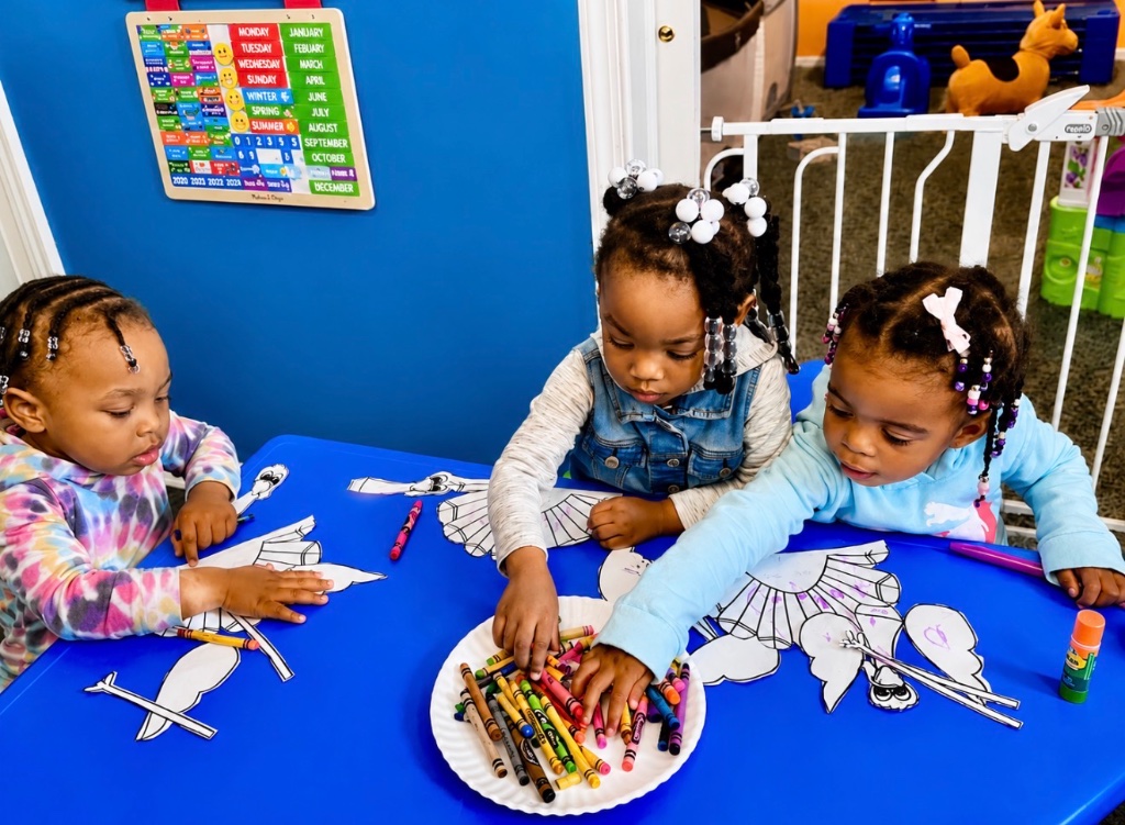 Creative Coloring Together Children coloring together during an arts and crafts activity at Insight Kidz Care in Baltimore.