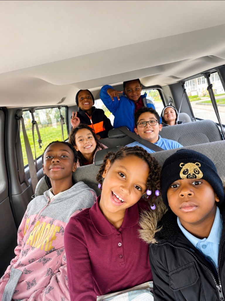 Happy children riding safely inside an Insight Kidz Care transportation van in Baltimore