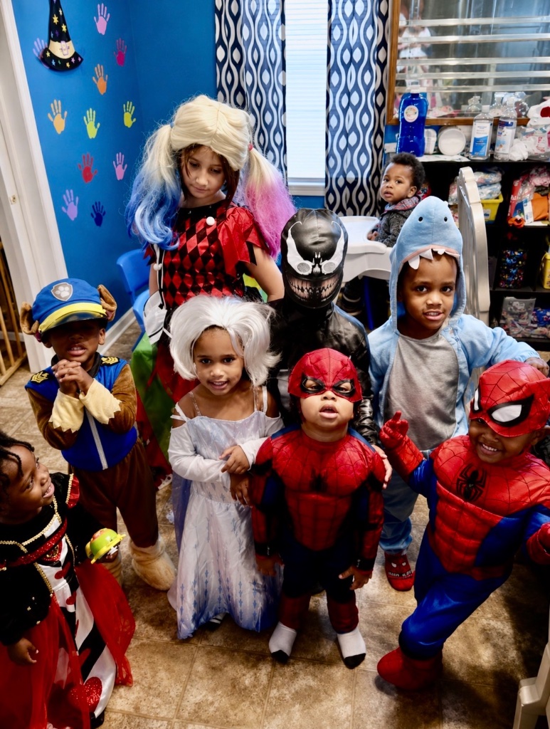 Halloween Costume Party Children dressed in Halloween costumes including superhero and princess outfits celebrating at Insight Kidz Care licensed family child care in Baltimore