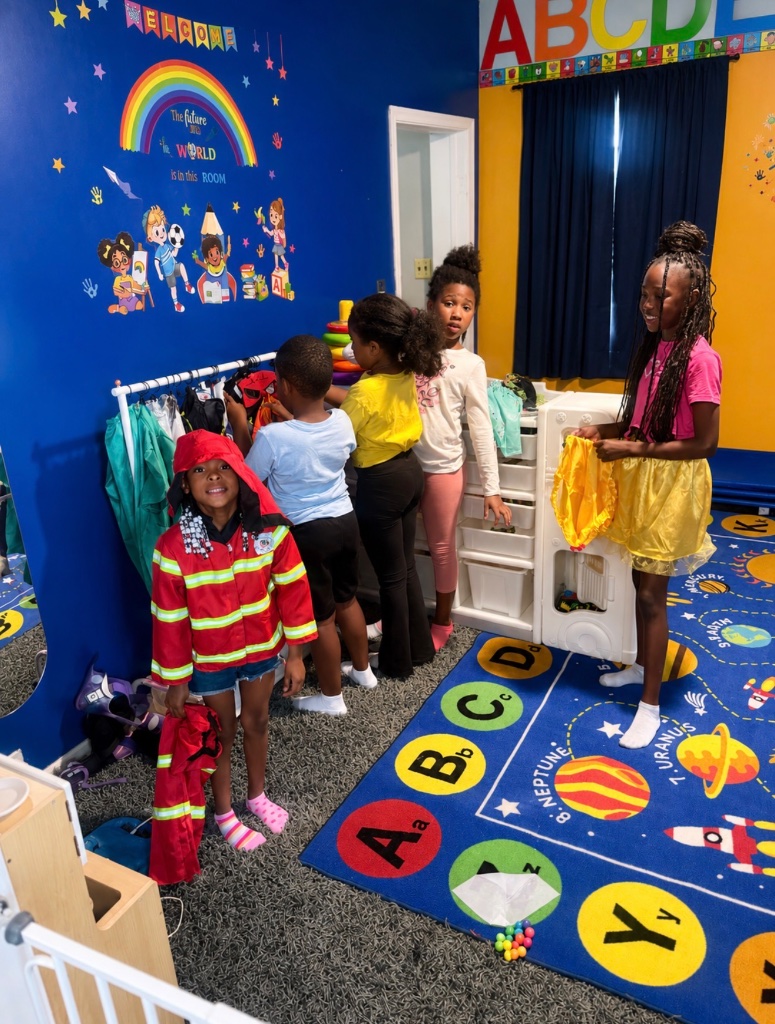 Dramatic Play: Firefighter Children dressed in dramatic play costumes including a firefighter outfit exploring imagination and role play at Insight Kidz Care Baltimore