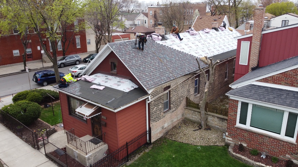 GOAT Restoration LLC crew installing roof in Chicago