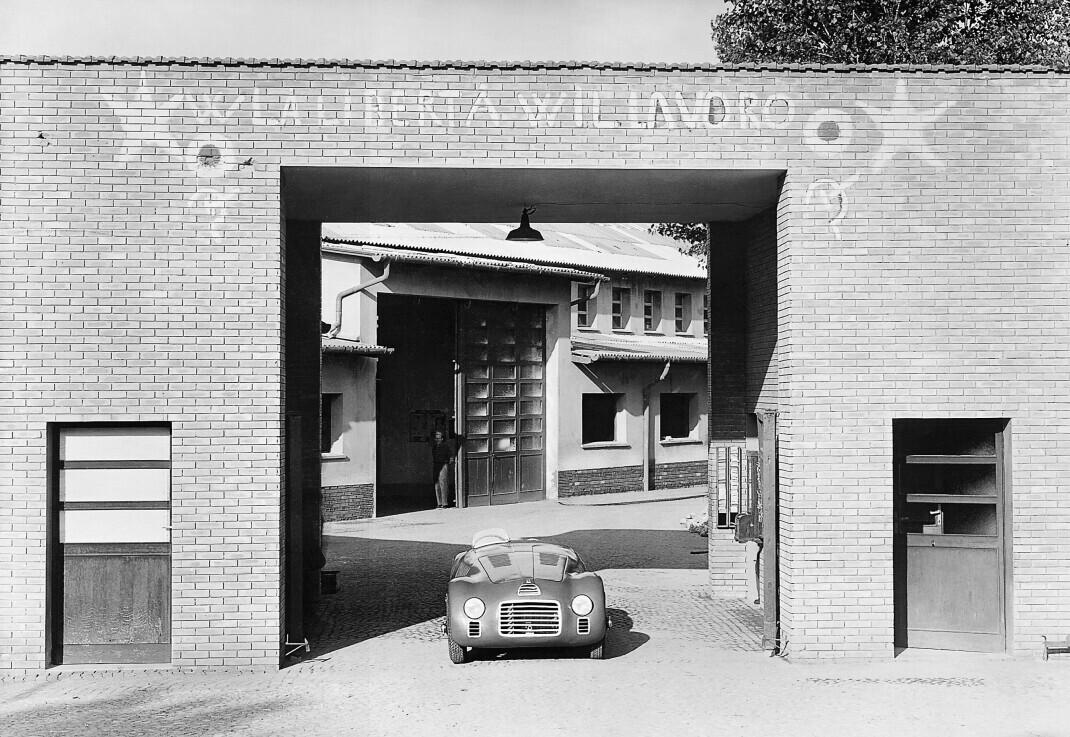 Historic black-and-white view of the original Ferrari factory entrance in Maranello.