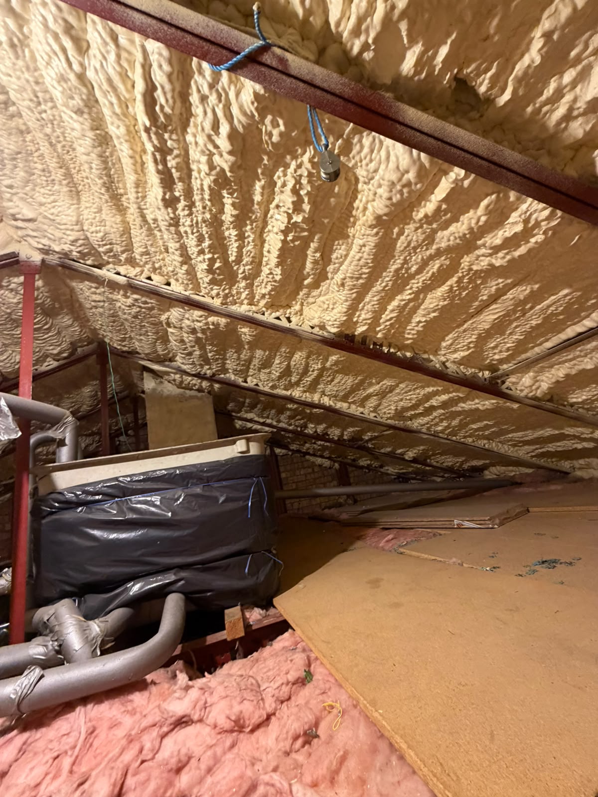 Before — spray foam applied directly to the roof deck, blocking the eaves