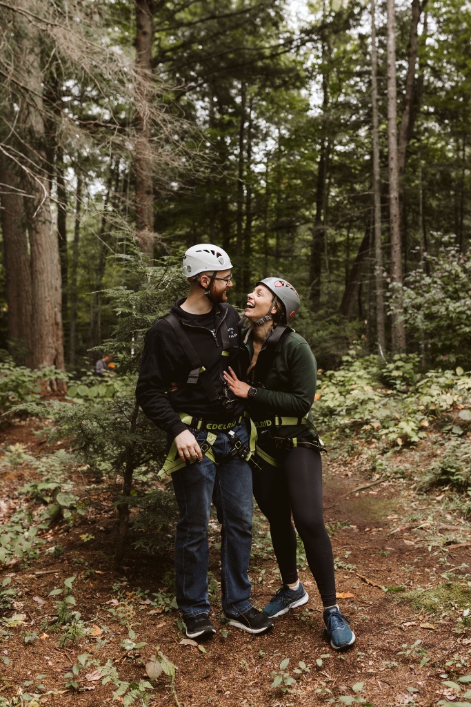 Couple at the climbing wall in the forest
