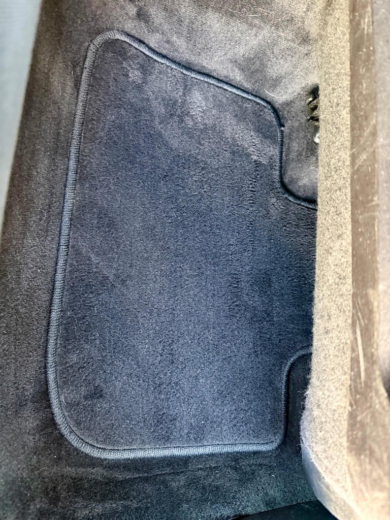 Dirty car floor mat before professional detailing Lethbridge