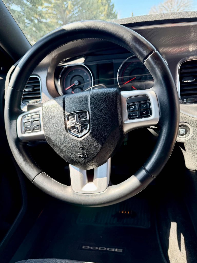 Dodge steering wheel and interior before professional detailing Lethbridge
