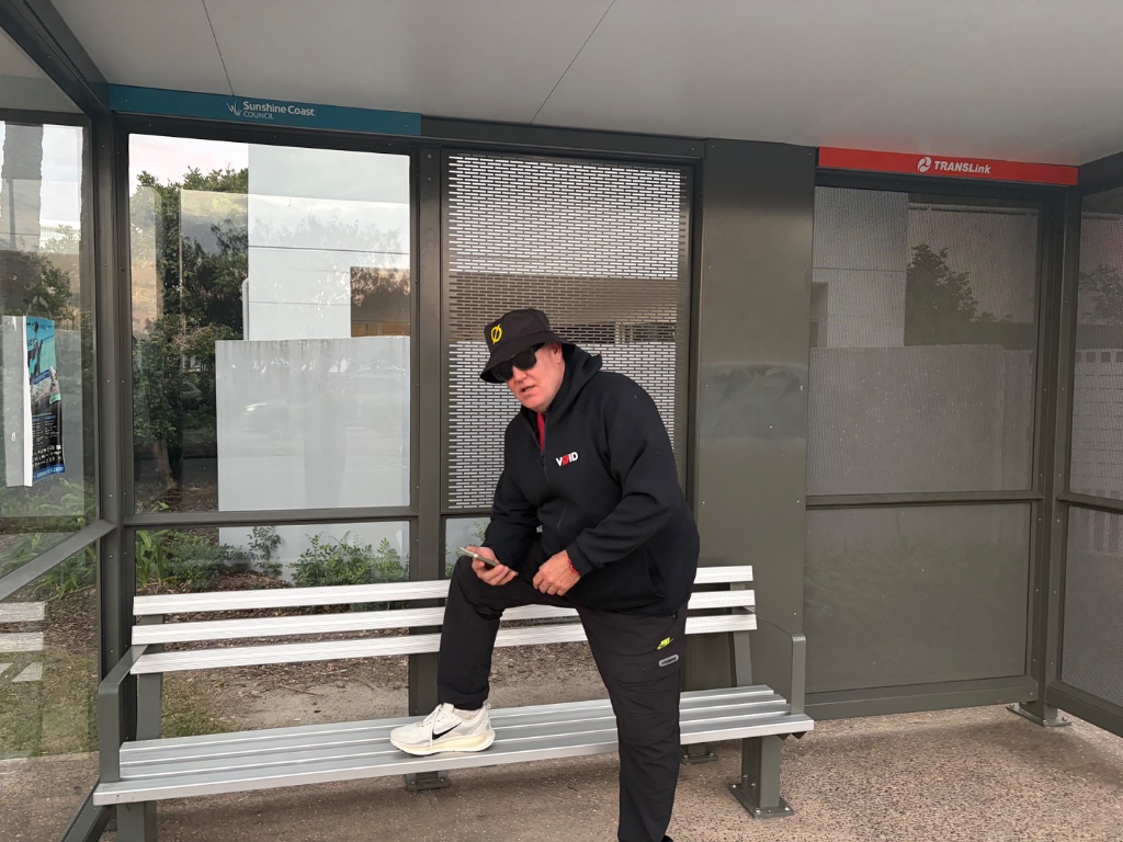 Waggsy at a Sunshine Coast bus stop in VØID gear