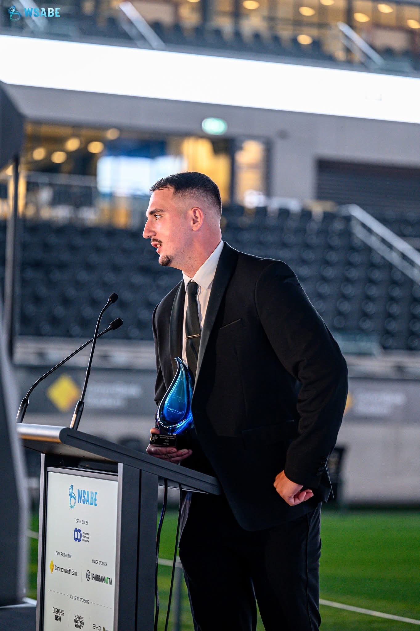 Jacob Betar at the WSABE podium holding the Outstanding New Business award