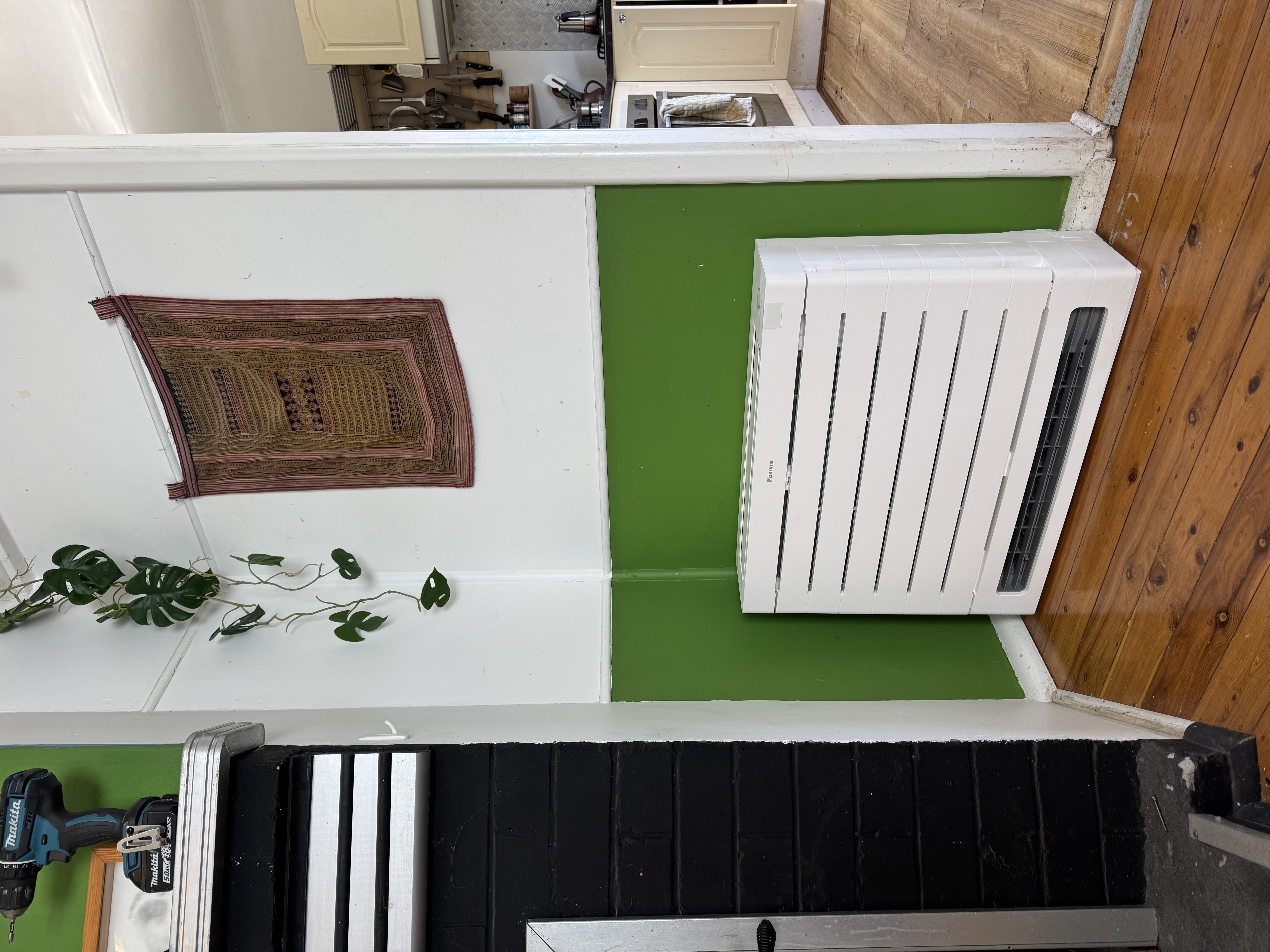 Daikin floor-console air conditioner with its casing fitted beside a fireplace at a Katoomba property