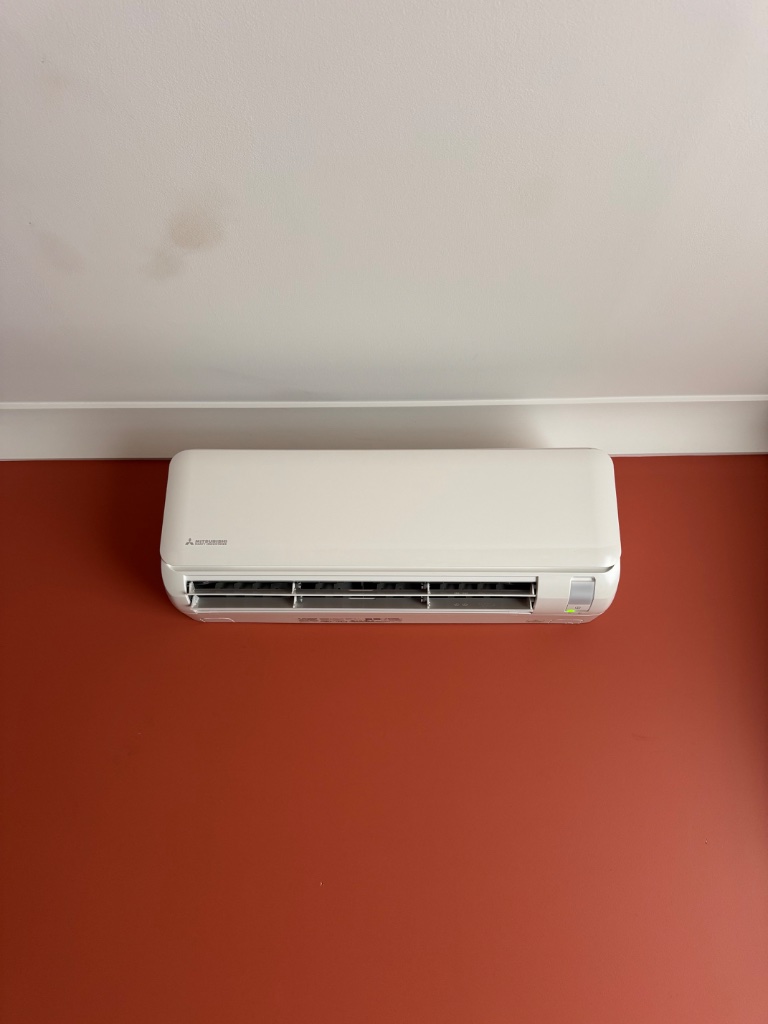 Mitsubishi Heavy Industries Ciara split system on a burnt orange wall in a Leura home