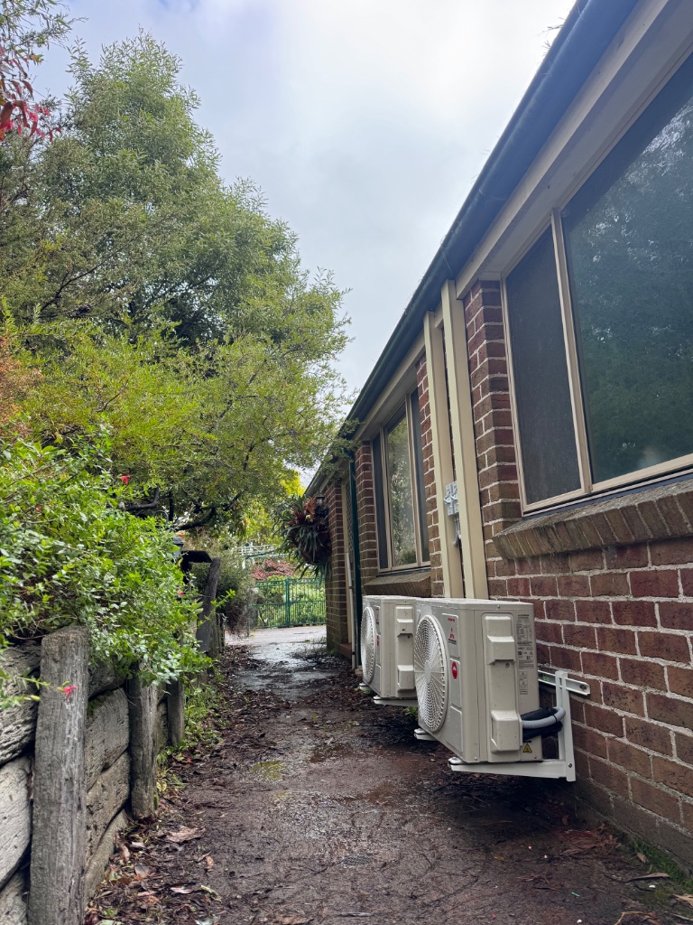 Two Mitsubishi Heavy Industries outdoor units wall-mounted on a brick exterior in Leura