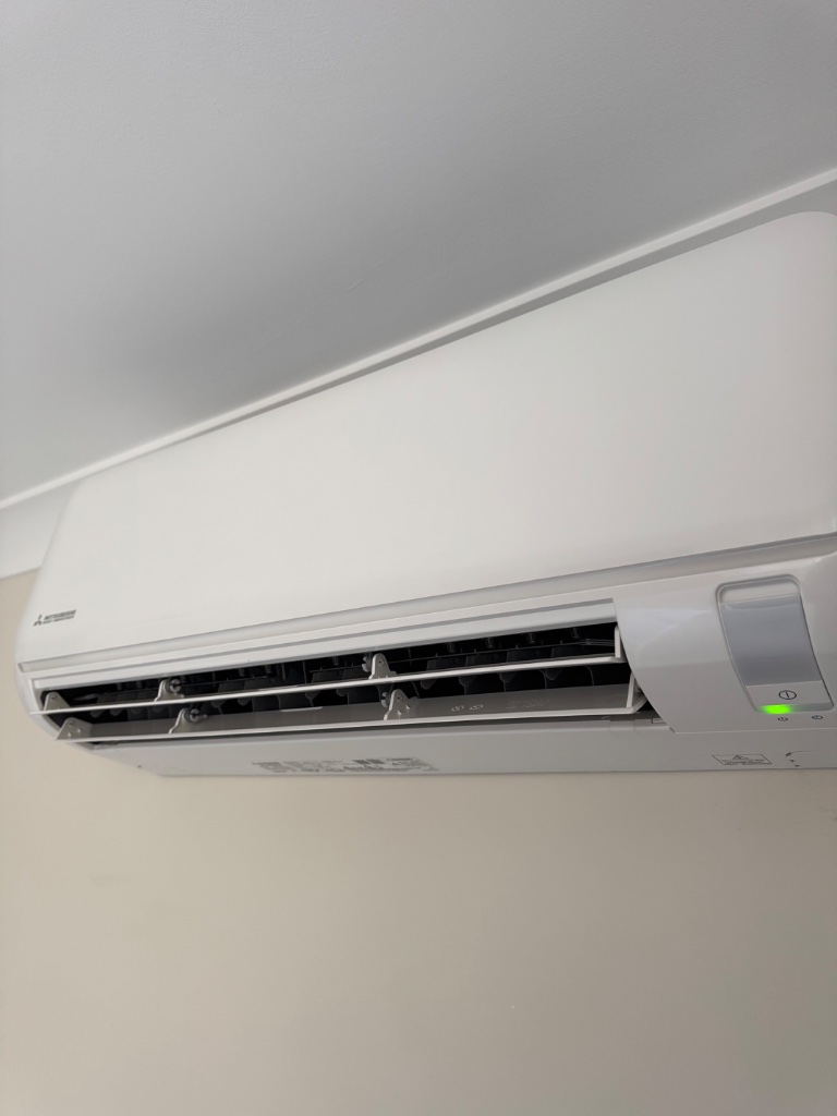 Close-up of Mitsubishi Heavy Industries Ciara split system unit showing green LED indicator