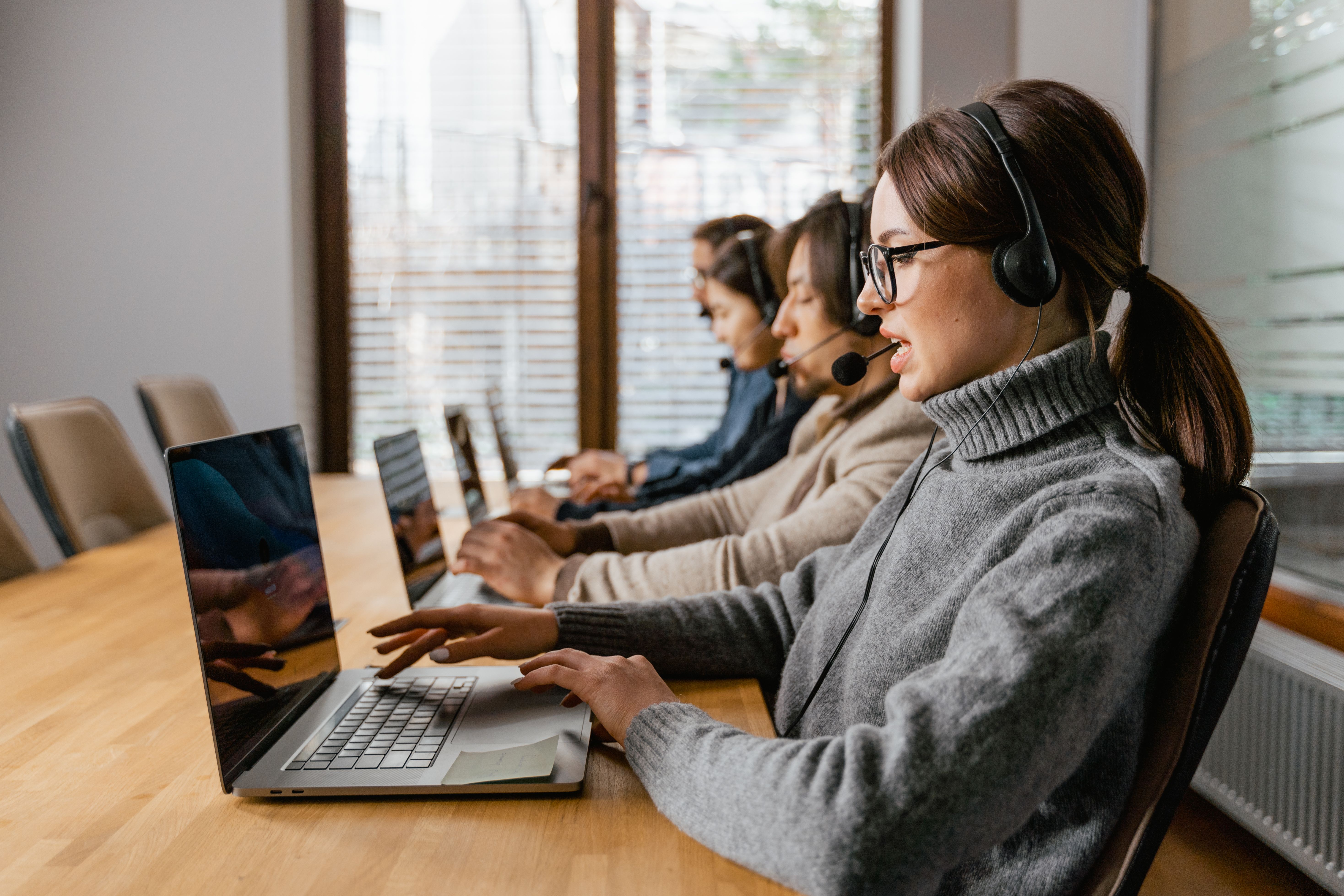 Customer support team working on laptops