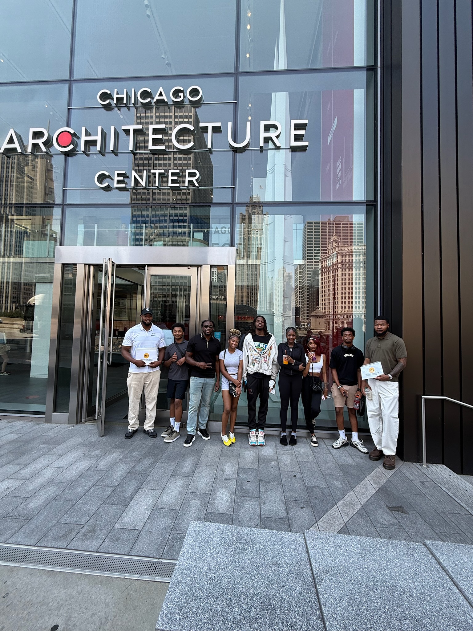 Group of students and mentors posing in front of the Chicago Architecture Center